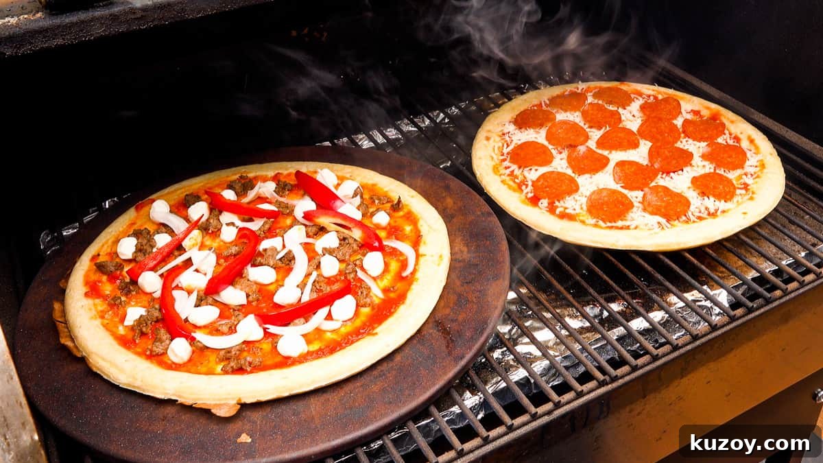 two pizzas on smoker rack cooking