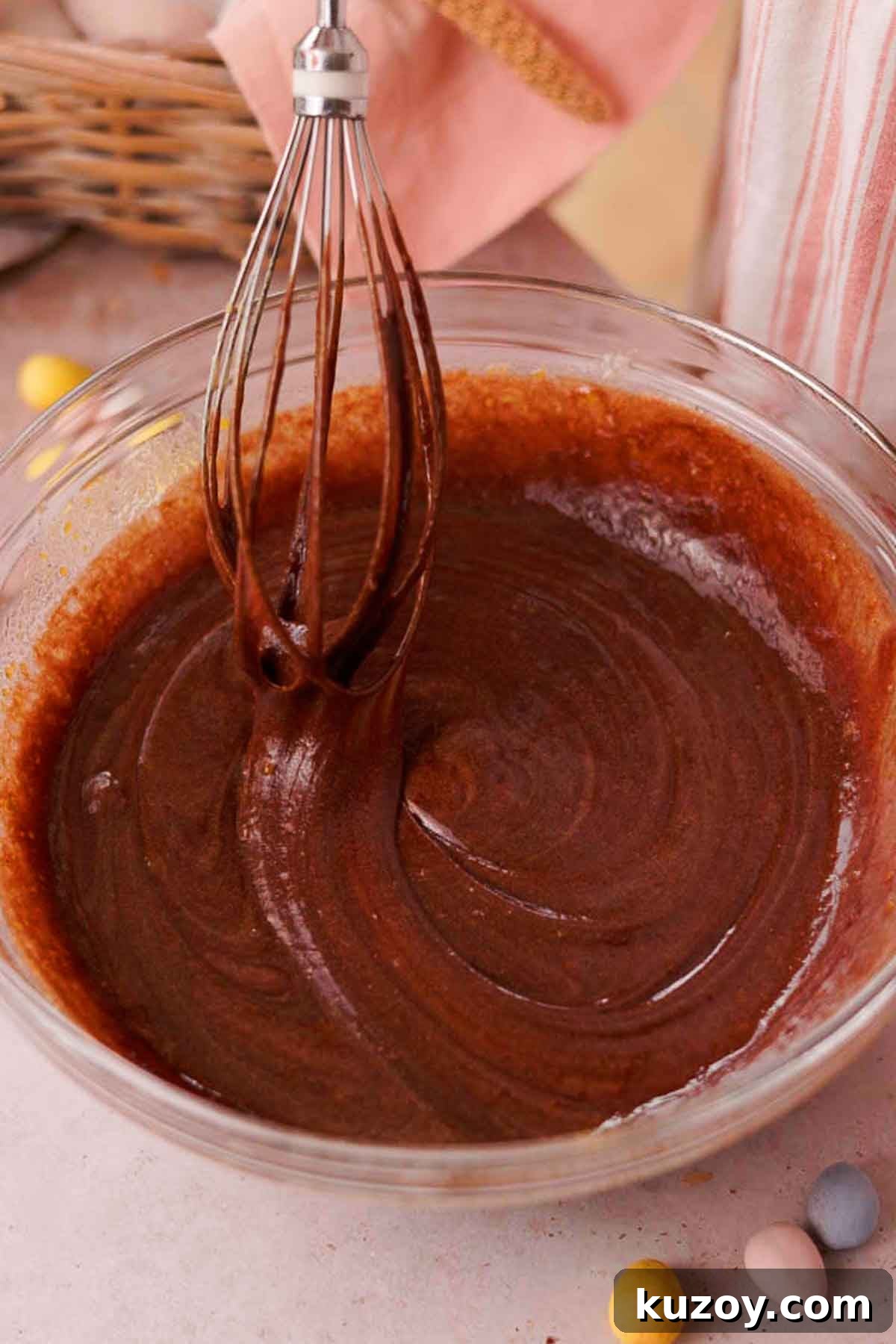 Mini Egg Brownies Recipe for Rich, Fudgy Easter Treats 7 whisking brownie batter with whisk in clear glass bowl