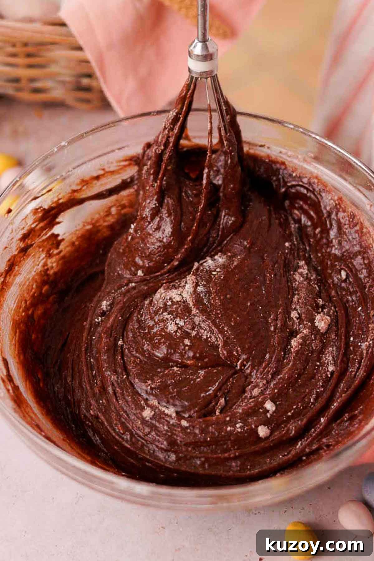 Mini Egg Brownies Recipe for Rich, Fudgy Easter Treats 8 folding brownie batter with a whisk in glass bowl