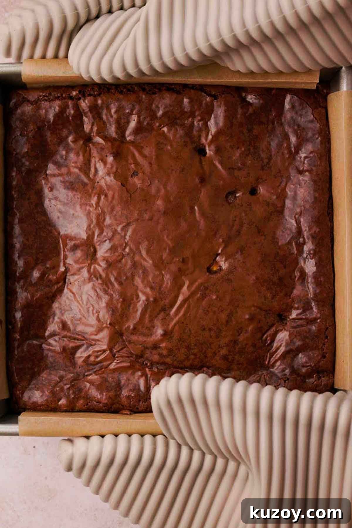 Mini Egg Brownies Recipe for Rich, Fudgy Easter Treats 10 holding baking pan with hot mini egg brownies using oven mitts
