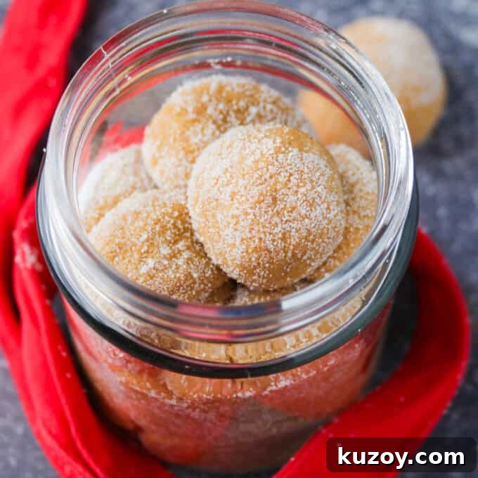 dulce de leche pastillas in a mason jar with red ribbon in the background.