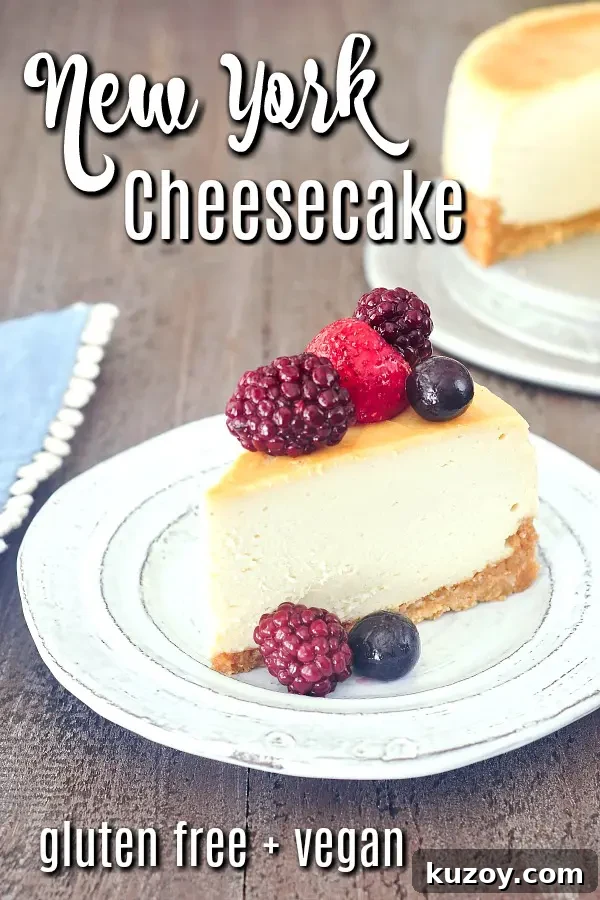 Vegan New York Cheesecake @spabettie #dairyfree #glutenfree #vegan #cheesecake #dessert one slice of vegan New York cheesecake on a plate with mixed berries on top, the remaining cheesecake in background
