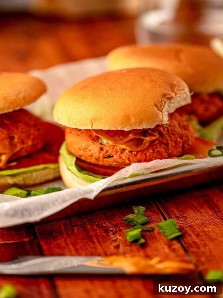 Salmon burgers on a tray.