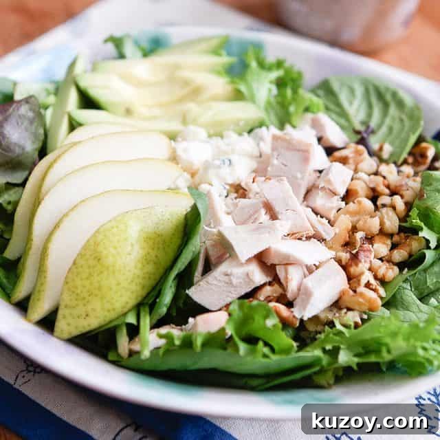 Chicken Pear and Avocado Salad close up of salad with pears, chopped rotisserie chicken, walnuts and avocado