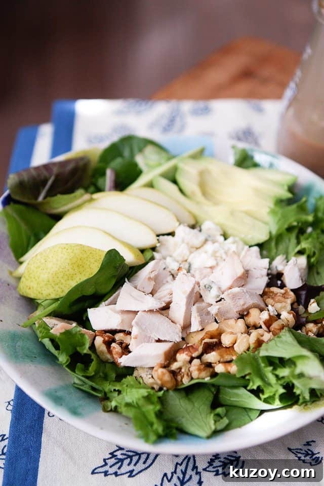 Chicken, Pear & Avocado Salad with Honey-Lime Dressing 4 close up of salad with chopped rotisserie chicken, walnuts and sliced pears and avocado