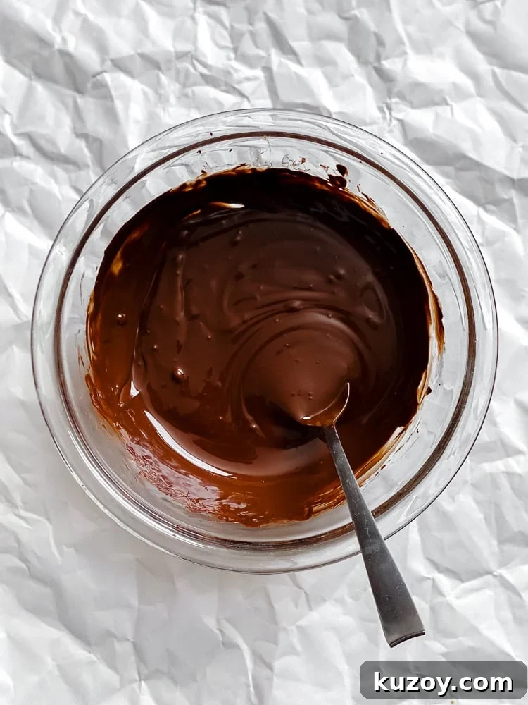 Process shot showing melted vegan chocolate in a bowl.