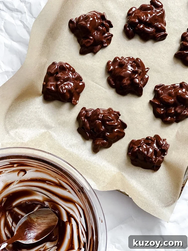 Process shot showing pre frozen peanut clusters on baking sheet.