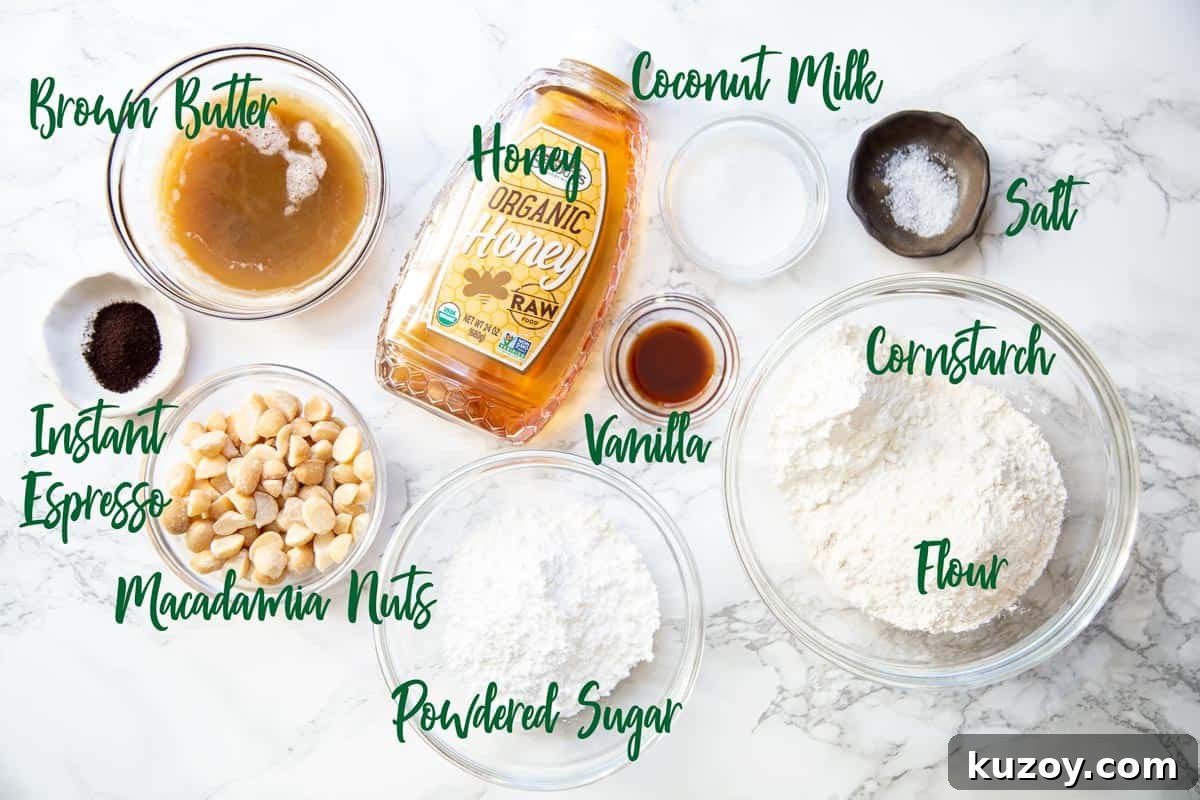 Ingredients for macadamia snowball cookies on a marble board.