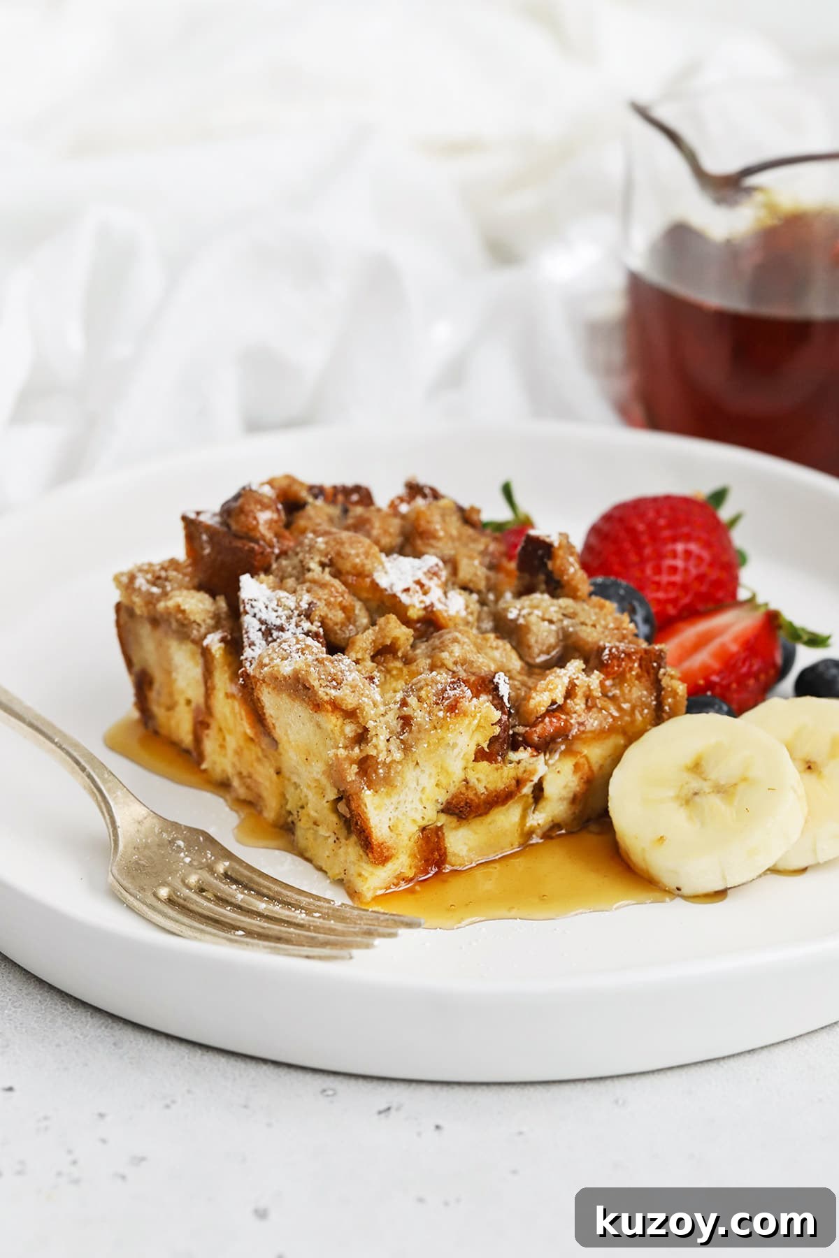 Gluten-Free Eggnog French Toast Casserole Recipe for Holidays 2 Front view of gluten-free eggnog french toast casserole topped with powdered sugar and maple syrup