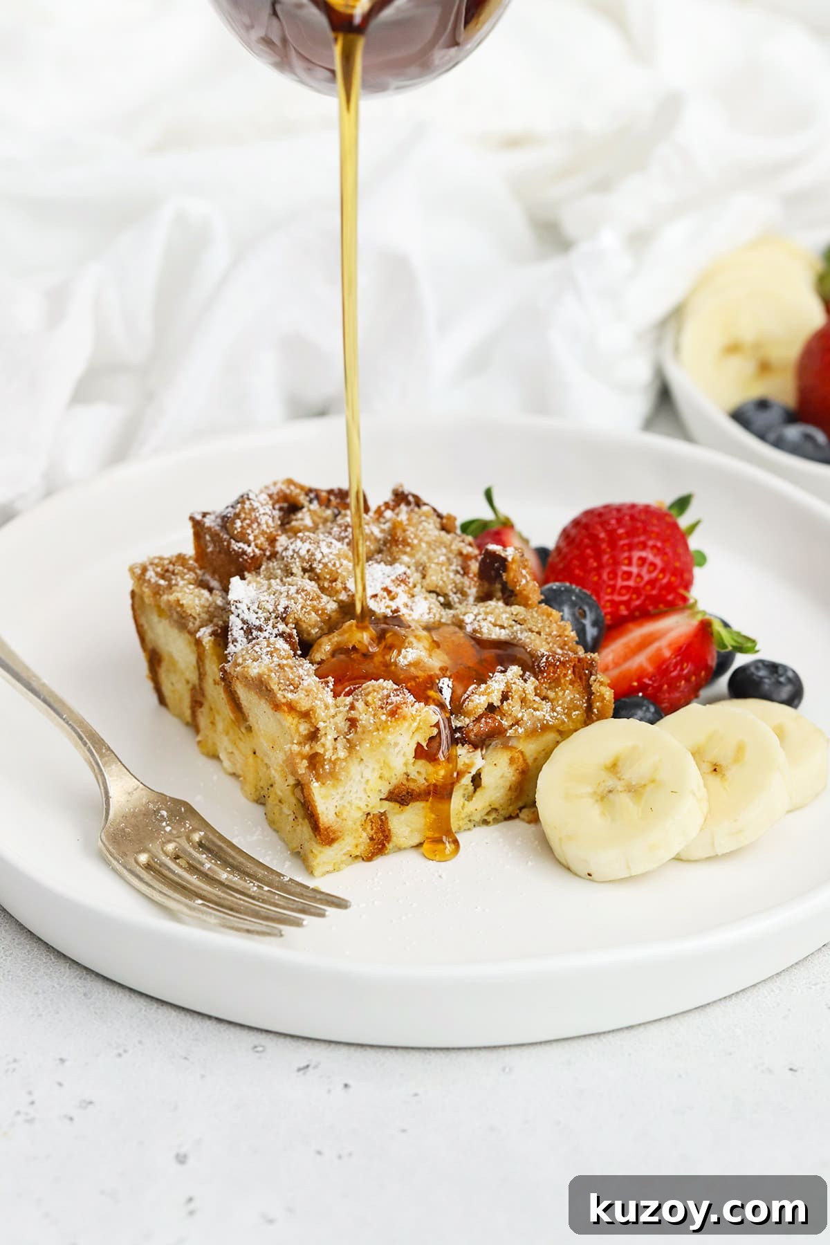 Gluten-Free Eggnog French Toast Casserole Recipe for Holidays 14 Pouring maple syrup on a slice of gluten-free eggnog french toast casserole