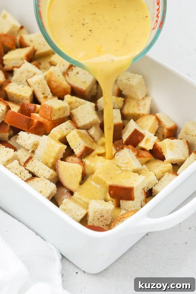 Gluten-Free Eggnog French Toast Casserole Recipe for Holidays 6 Pouring eggnog custard onto bread cubes
