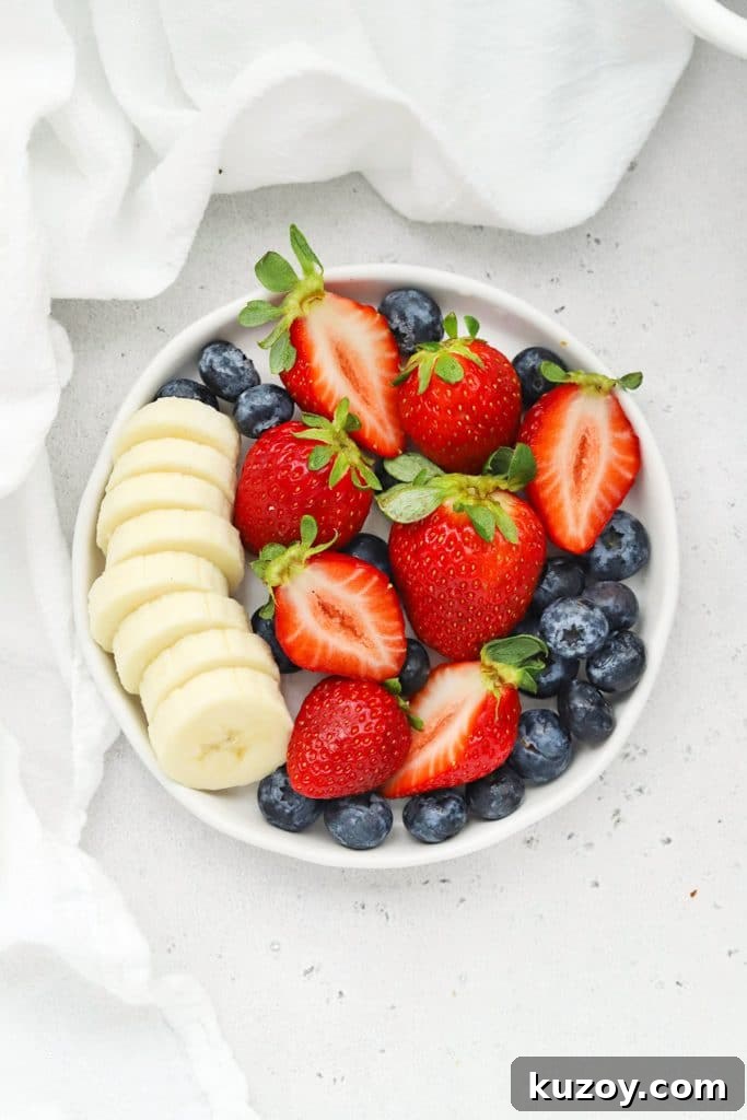 Gluten-Free Eggnog French Toast Casserole Recipe for Holidays 10 Plate of fresh strawberries, blueberries, and sliced bananas