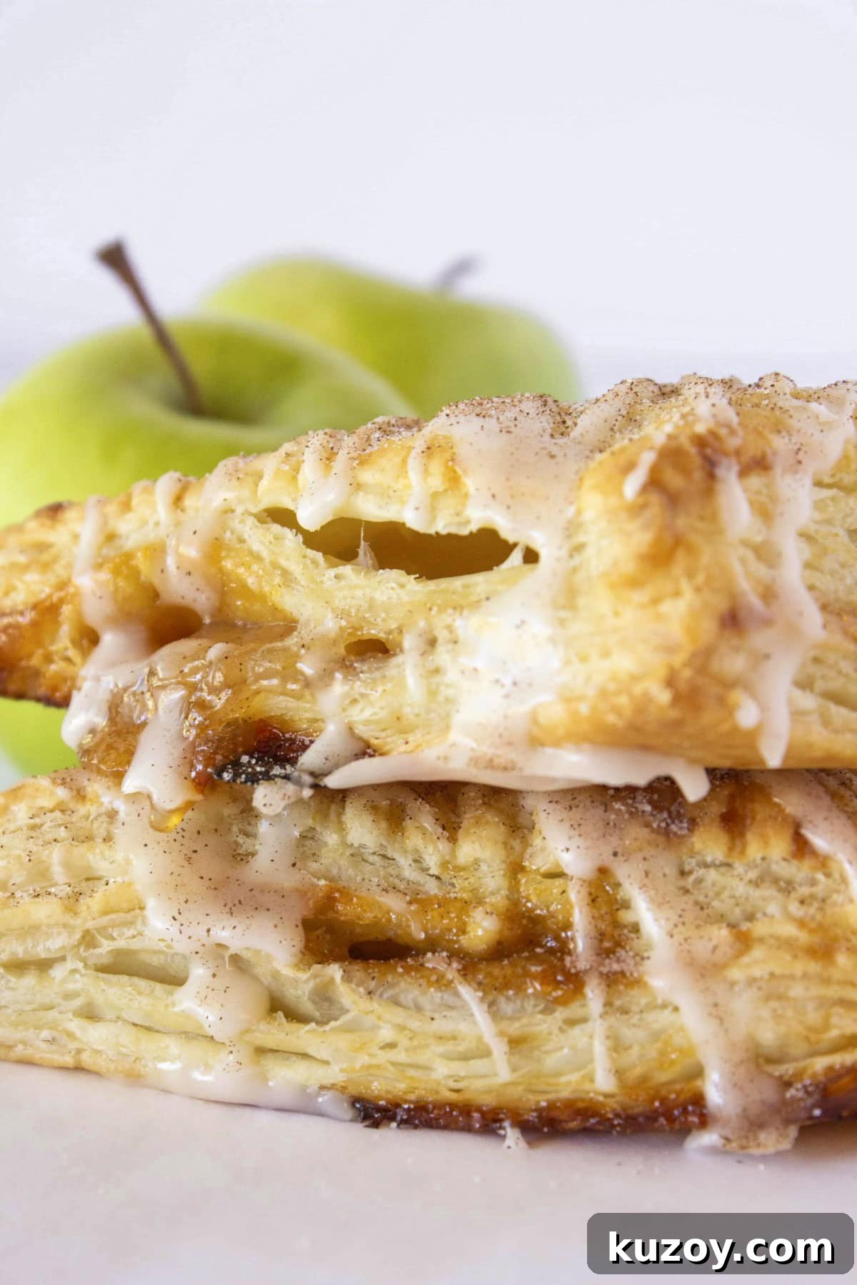 Caramel Apple Turnovers Recipe: Flaky Pastry with Gooey Filling 2 Two caramel apple turnovers stacked on each other.