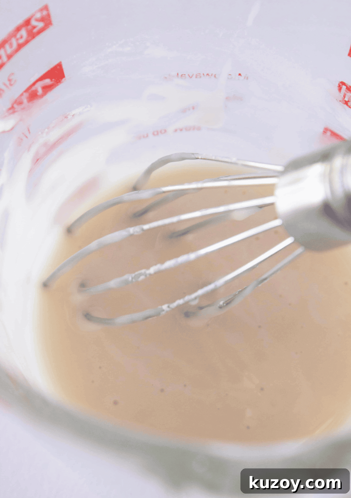 Caramel Apple Turnovers Recipe: Flaky Pastry with Gooey Filling 8 Whisking together the glaze ingredients.
