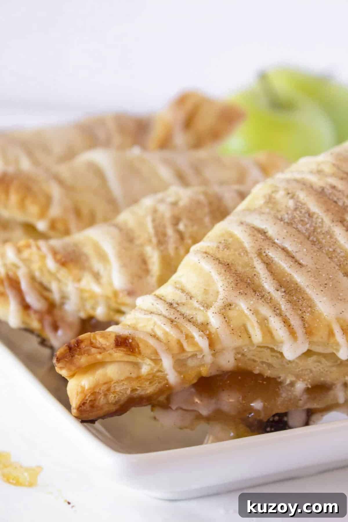 Caramel Apple Turnovers Recipe: Flaky Pastry with Gooey Filling 10 Caramel Apple Turnovers on a white plate for breakfast.