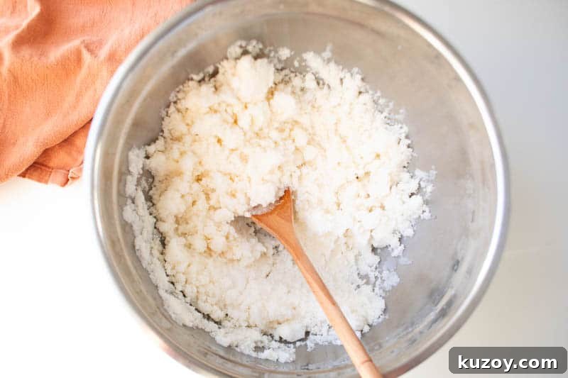 Snow Ice Cream Recipe Without Condensed Milk — Simple & Creamy 5 A large bowl of homemade snow cream being stirred with a wooden spoon