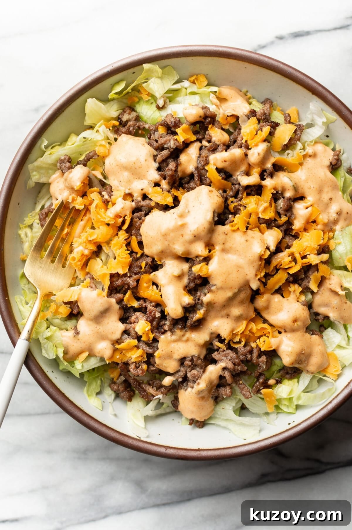 Copycat Big Mac Salad Recipe: Flavor-Packed Cheeseburger Salad 2 a bowl of big mac salad with a fork