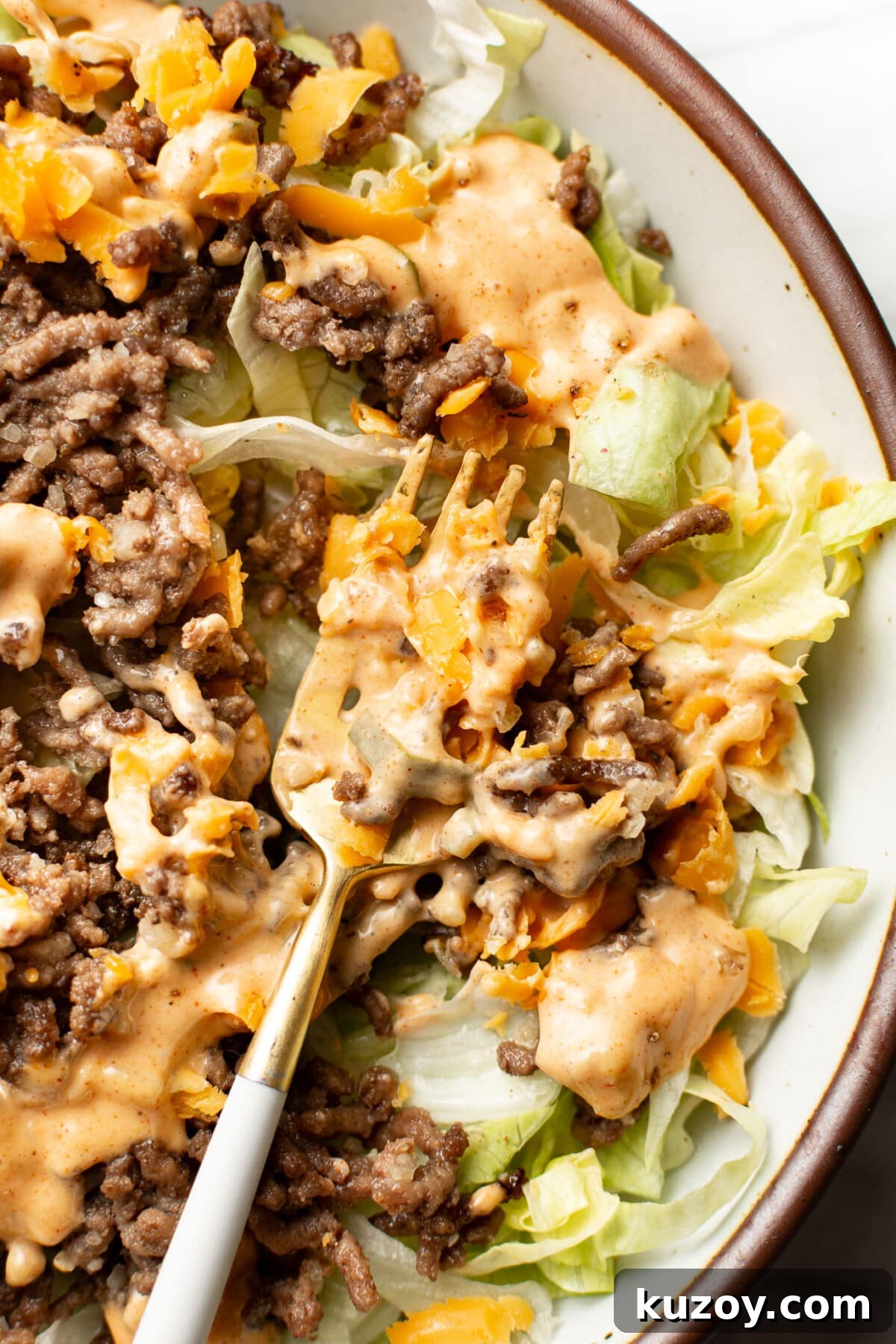 Copycat Big Mac Salad Recipe: Flavor-Packed Cheeseburger Salad 6 closeup of a bowl of big mac salad with a fork