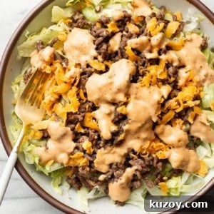 Copycat Big Mac Salad Recipe: Flavor-Packed Cheeseburger Salad 7 a bowl of big mac salad with a fork