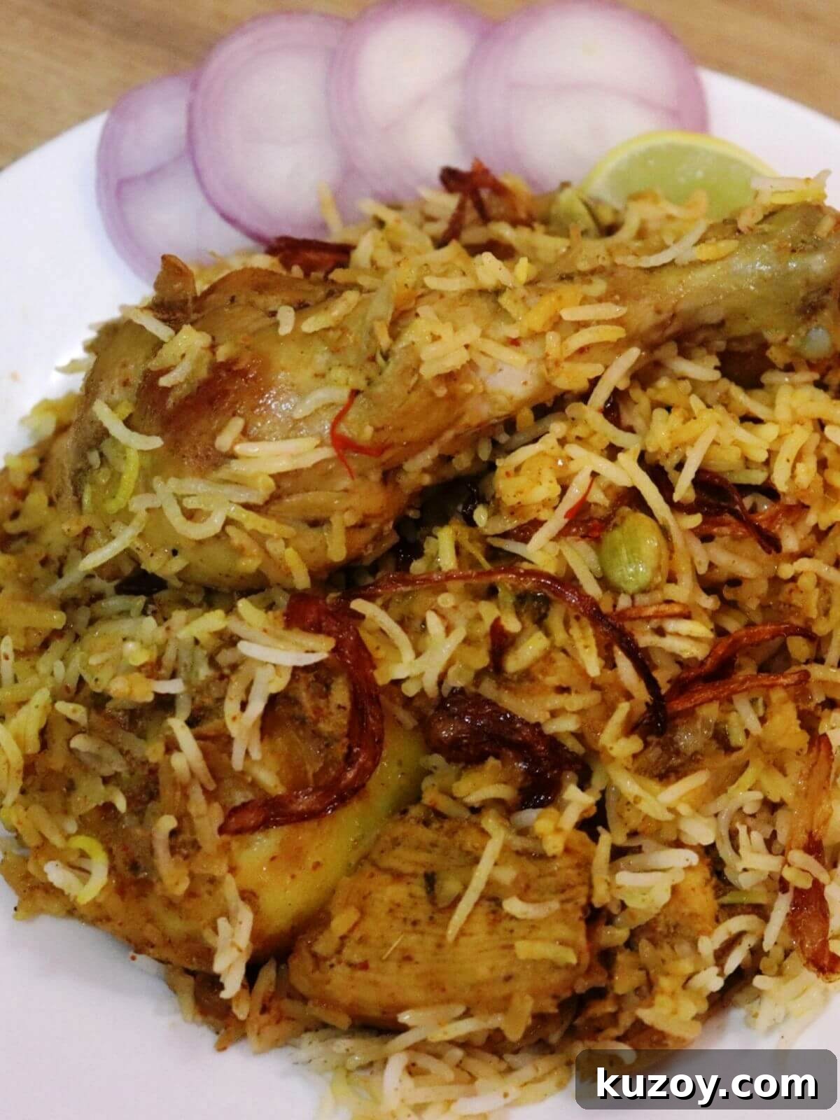 Kolkata-Style Chicken Biryani: Authentic Bengali Recipe 2 close-up of kolkata chicken biryani served on a plate.