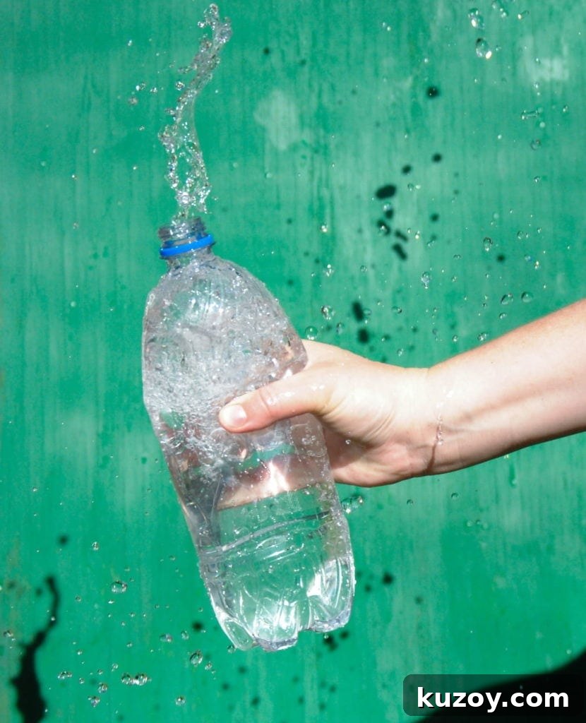 How Microplastics Are Contaminating the Food Industry and You 2 water splashing out of plastic water bottle with green background sideways