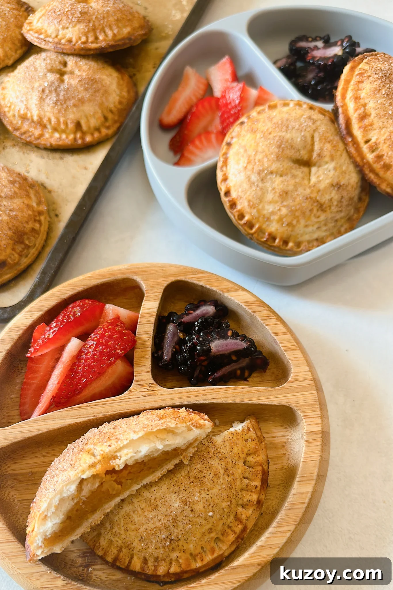 Sweet Potato Hand Pies Recipe: Flaky Crust & Savory-Sweet Filling 2 Sweet potato hand pies served with strawberries and blackberries.