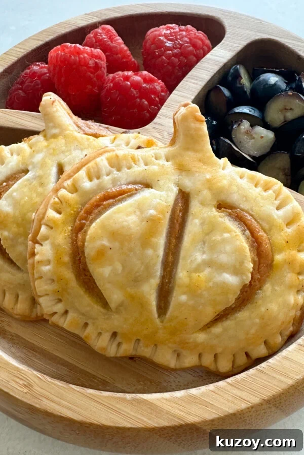 Sweet Potato Hand Pies Recipe: Flaky Crust & Savory-Sweet Filling 11 Pumpkin hand pies served with fruits.