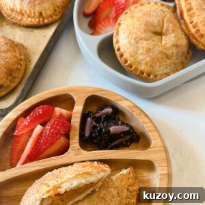 Sweet Potato Hand Pies Recipe: Flaky Crust & Savory-Sweet Filling 12 Sweet potato hand pies served with strawberries and blackberries.