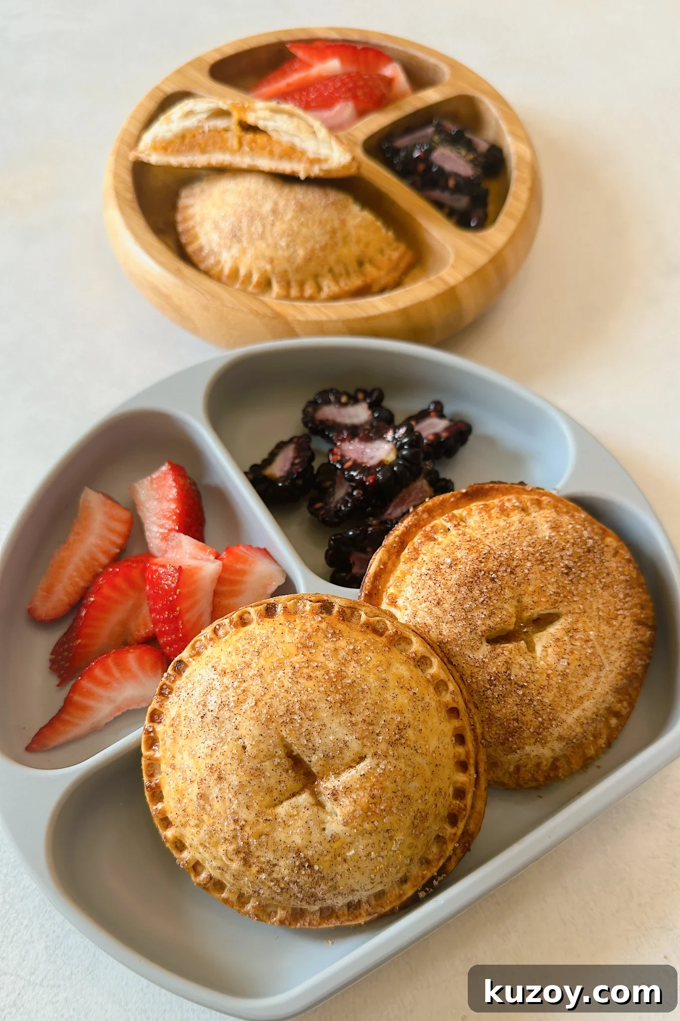 Sweet Potato Hand Pies Recipe: Flaky Crust & Savory-Sweet Filling 6 Sweet potato hand pies served with strawberries and blackberries.