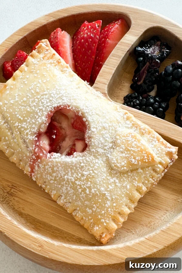 Sweet Potato Hand Pies Recipe: Flaky Crust & Savory-Sweet Filling 8 Strawberry cream cheese hand pies served with berries.