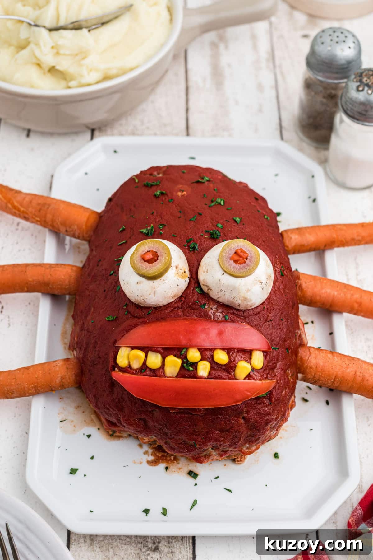 Spooky Monster Meatloaf Recipe for Halloween Dinner 2 A meatloaf monster ona a plate.