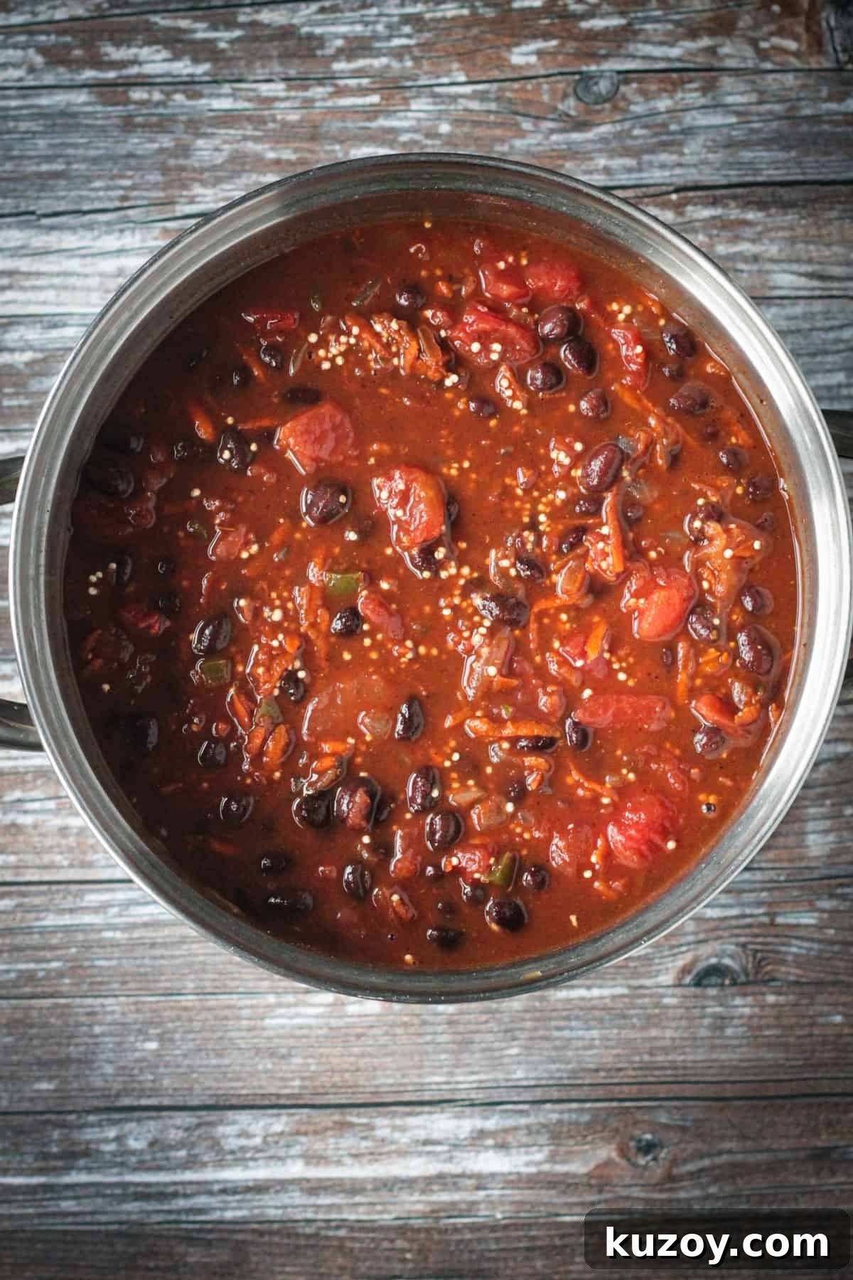 Hearty Black Bean and Quinoa Chili Recipe 6 Broth and tomatoes mixed with the beans and veggies.