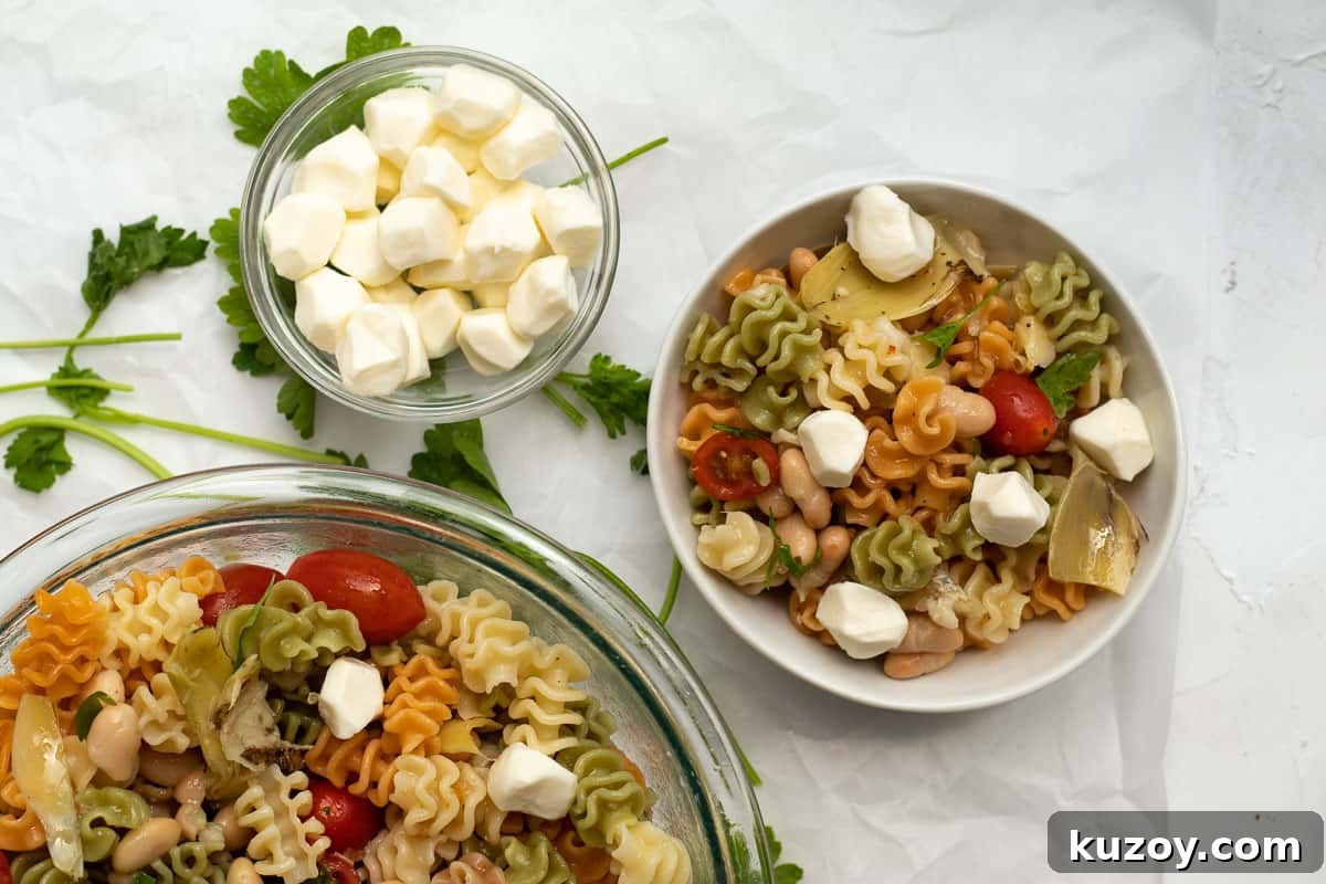 Zesty Italian Pasta Salad with 6 Simple Ingredients 8 adding mozzarella balls to the pasta salad