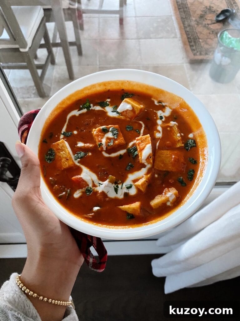 Paneer Makhani with Coconut Milk: Creamy Indian Curry Recipe 5 hand holding the paneer makhani