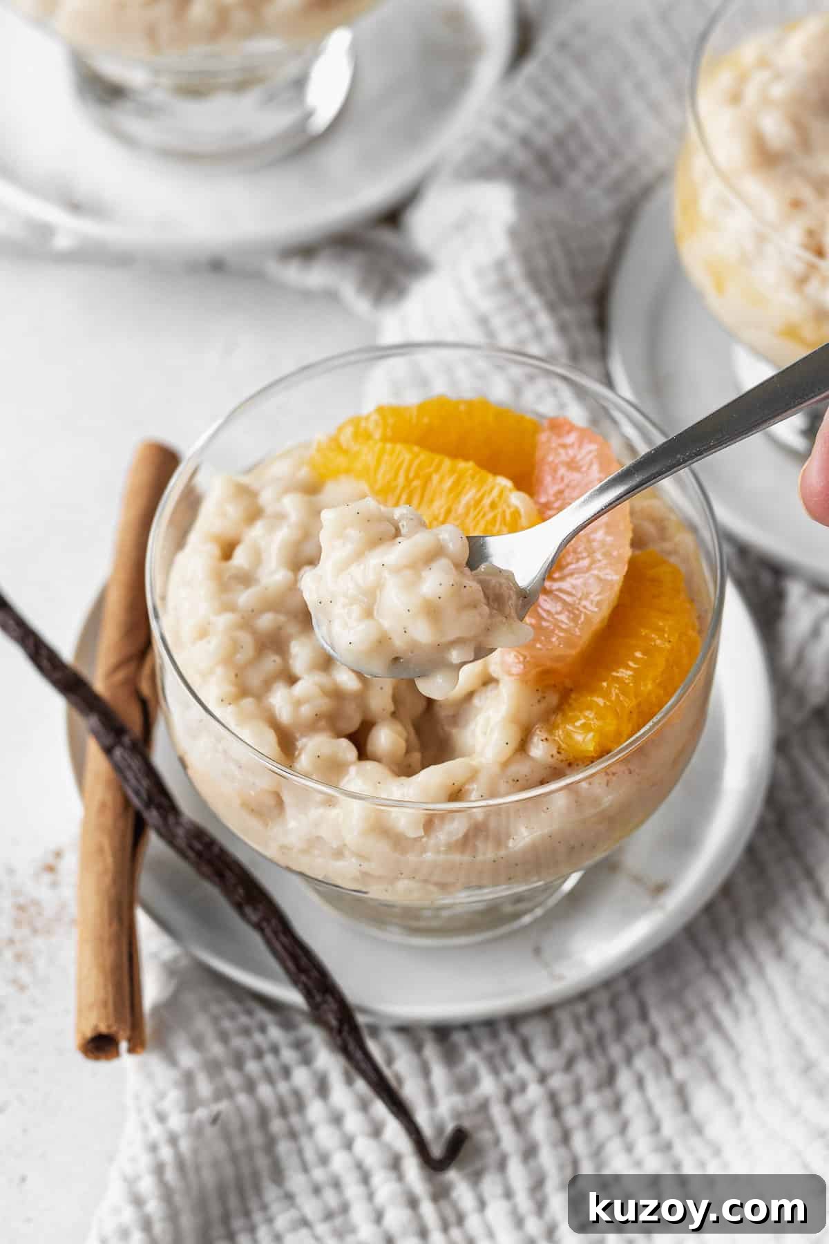 Creamy Dairy-Free Vegan Rice Pudding Recipe 11 A spoon scooping a bite of vegan rice pudding.