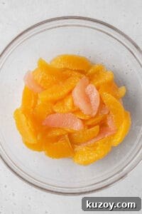 Creamy Dairy-Free Vegan Rice Pudding Recipe 8 Orange and grapefruit segments in a glass bowl.