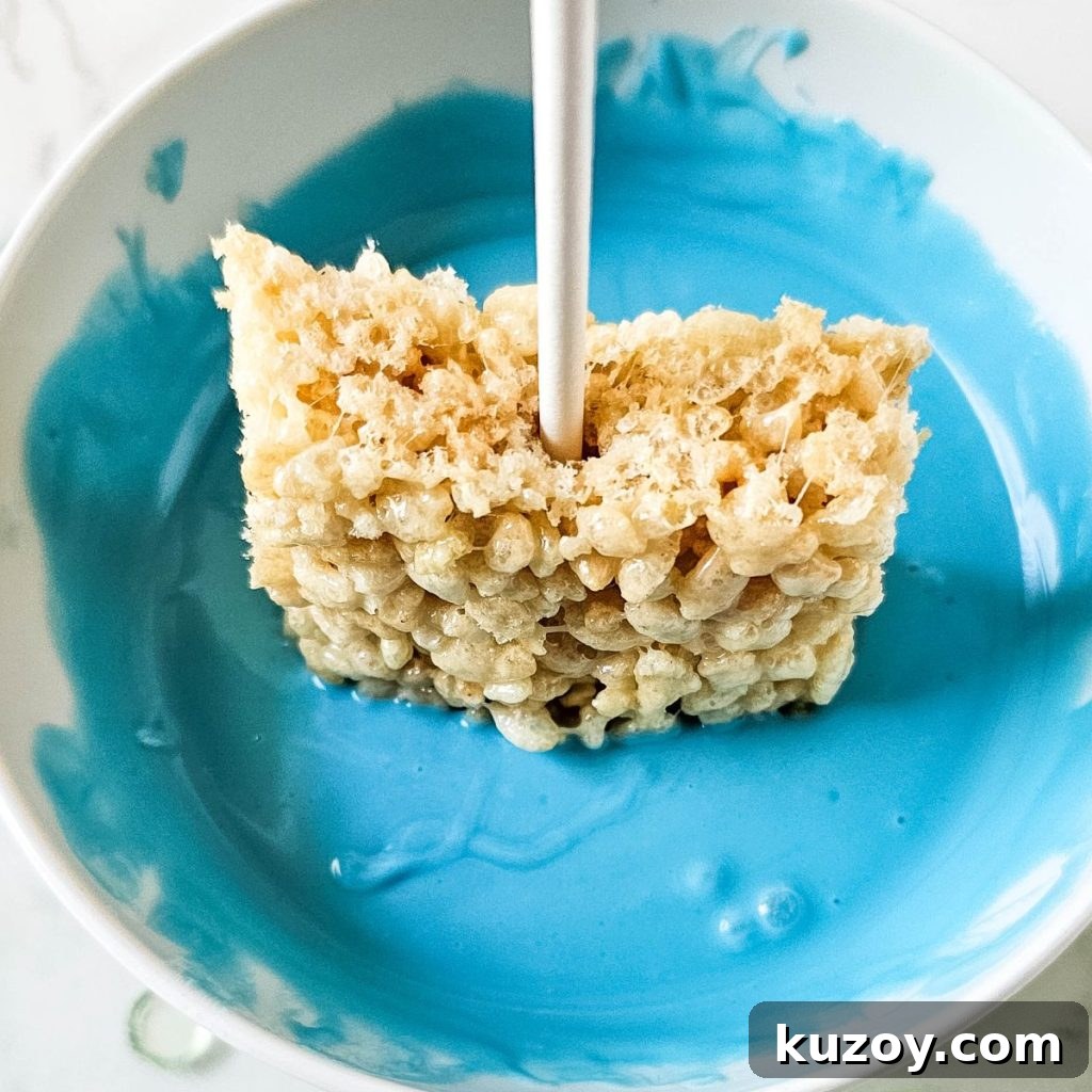 Blue Candy-Coated Rice Krispies Pops: Fun Party Treats 9 Dipping Krispies pops in blue candy