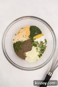 Homemade Ranch Seasoning Mix Recipe for Dips & Dressings 12 A bowl filled with a variety of herbs, seasonings, salt, etc.