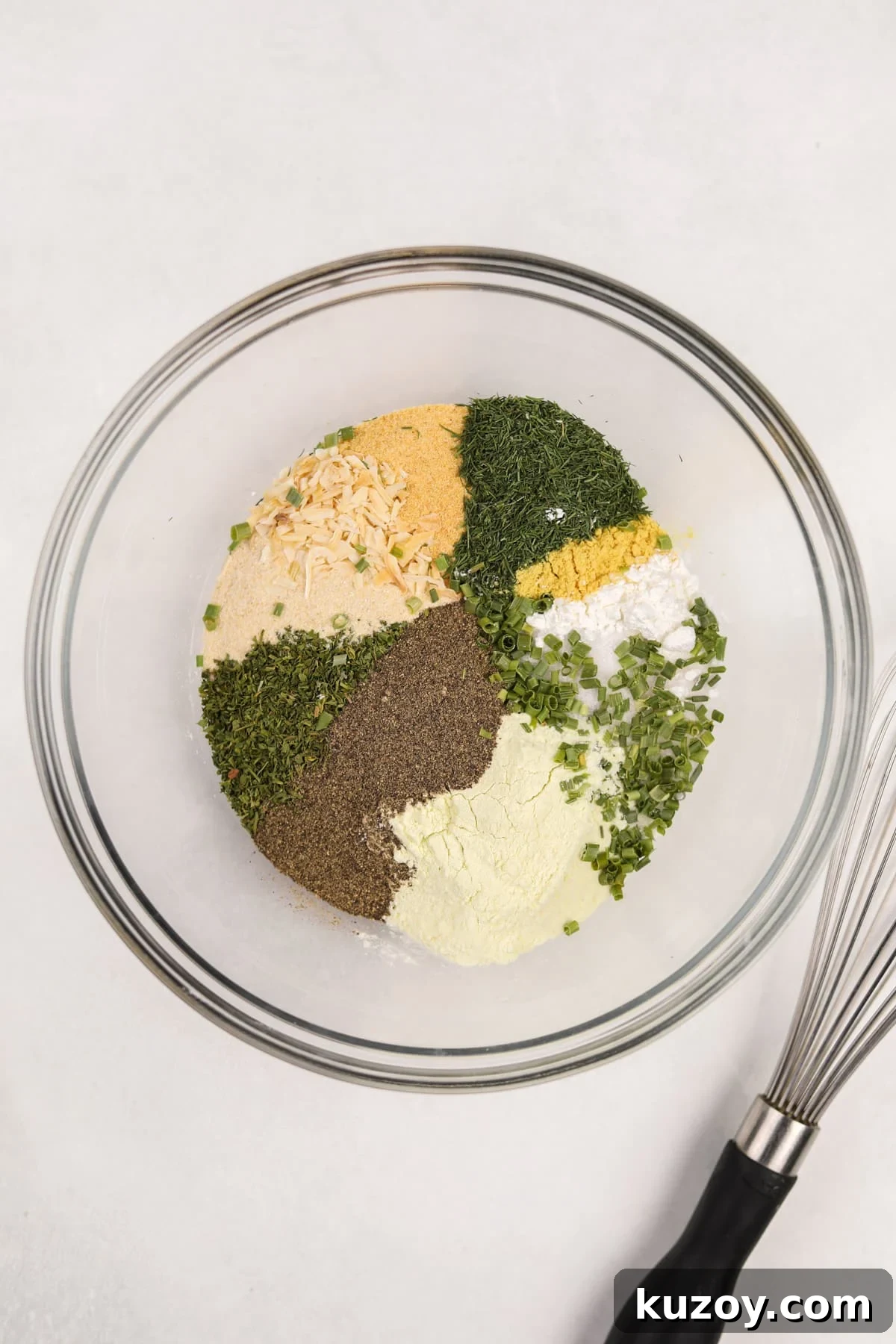 Homemade Ranch Seasoning Mix Recipe for Dips & Dressings 4 A bowl filled with a variety of herbs, seasonings, salt, etc.