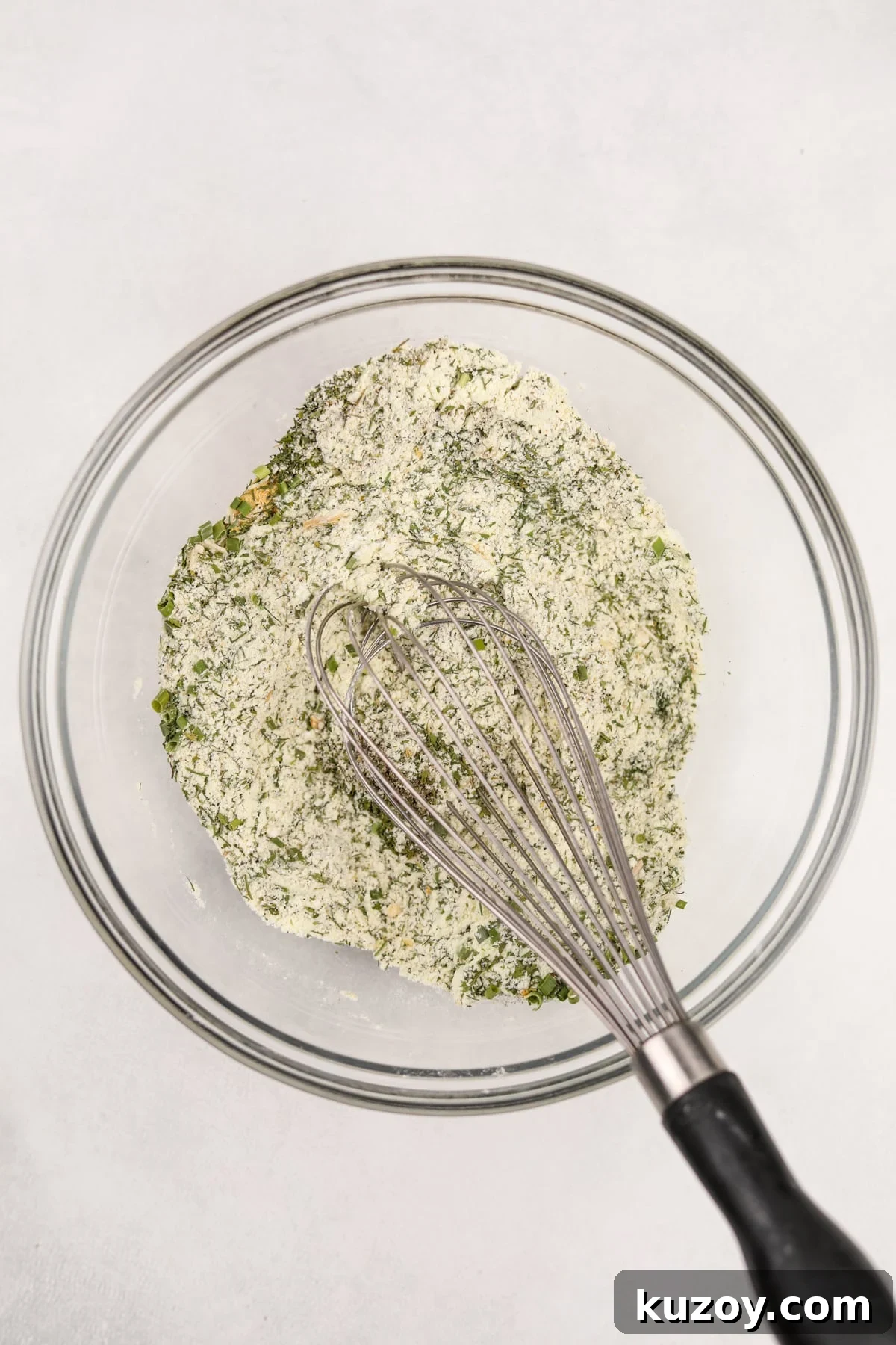 Homemade Ranch Seasoning Mix Recipe for Dips & Dressings 5 Whisking together herbs and buttermilk powder in a bowl.