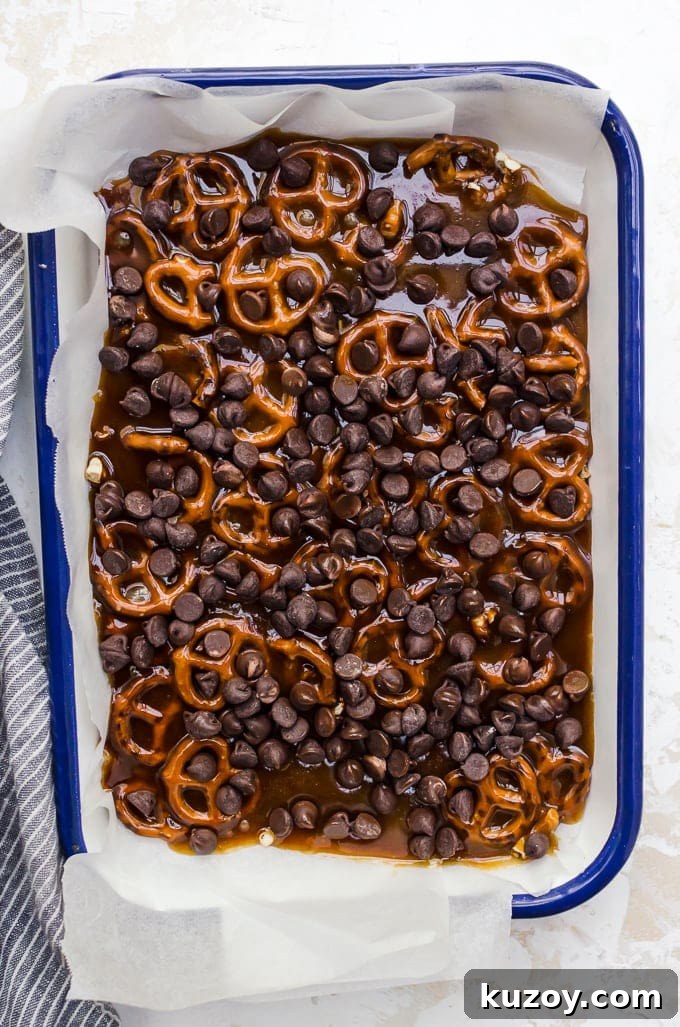 Salted Pretzel Toffee Bark Recipe for Irresistible Snacking 4 process shot overhead pretzel toffee bark topped with chocolate