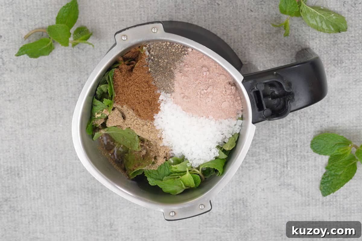 Mint, ginger, lime juice, sugar, cumin powder, chaat masala, black pepper powder, black salt, and ½ cup water added to a blender.