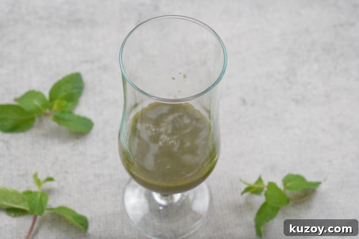 Some mint mixture added to a serving glass.
