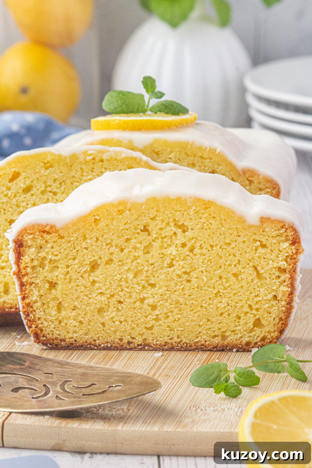 Starbucks-Style Lemon Loaf Recipe: Moist Citrus Quick Bread 2 A close-up view of sliced and glazed lemon loaf.