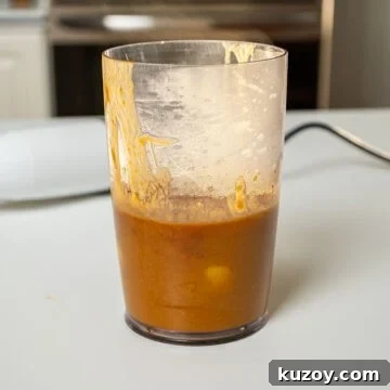 Peach Bourbon Glazed Pork Chops with Pan Sauce 7 Bourbon peach sauce blended in a measuring cup.