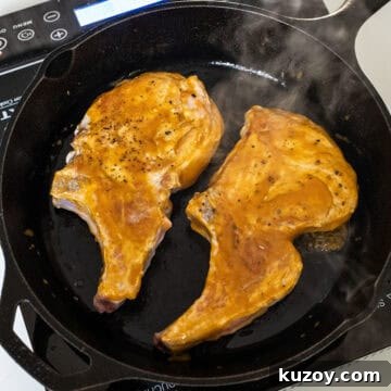 Peach Bourbon Glazed Pork Chops with Pan Sauce 9 Glazing pork chops in a cast iron.