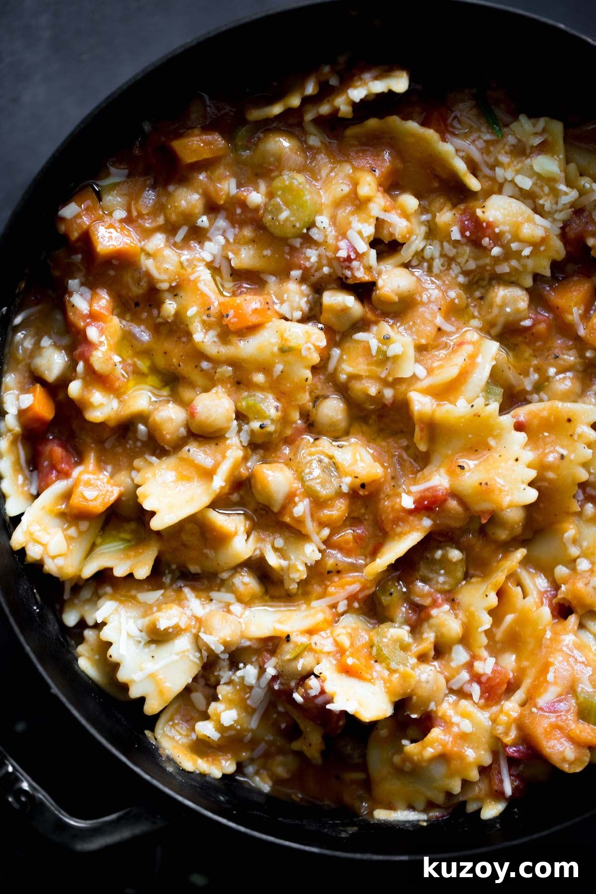 One-Pot Pasta e Ceci: Hearty Italian Pasta with Chickpeas 2 closeup photo of vegetarian pasta e ceci (pasta and chickpeas) in a big pot with dark gray background