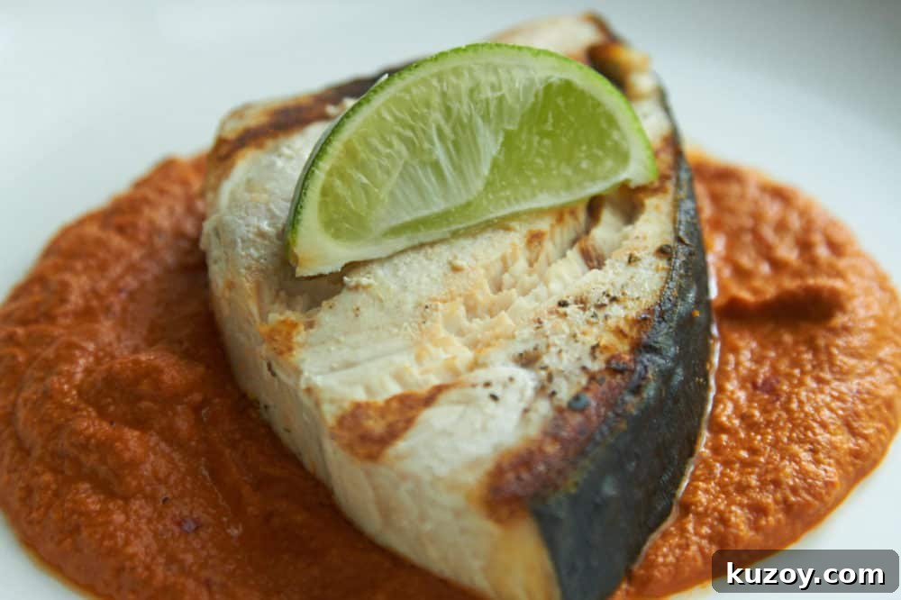 Orange-Almond Mole Sauce: Quick Recipe for Rich, Zesty Flavor 2 Grilled halibut with Almond orange mole, garnished with a lime wedge.