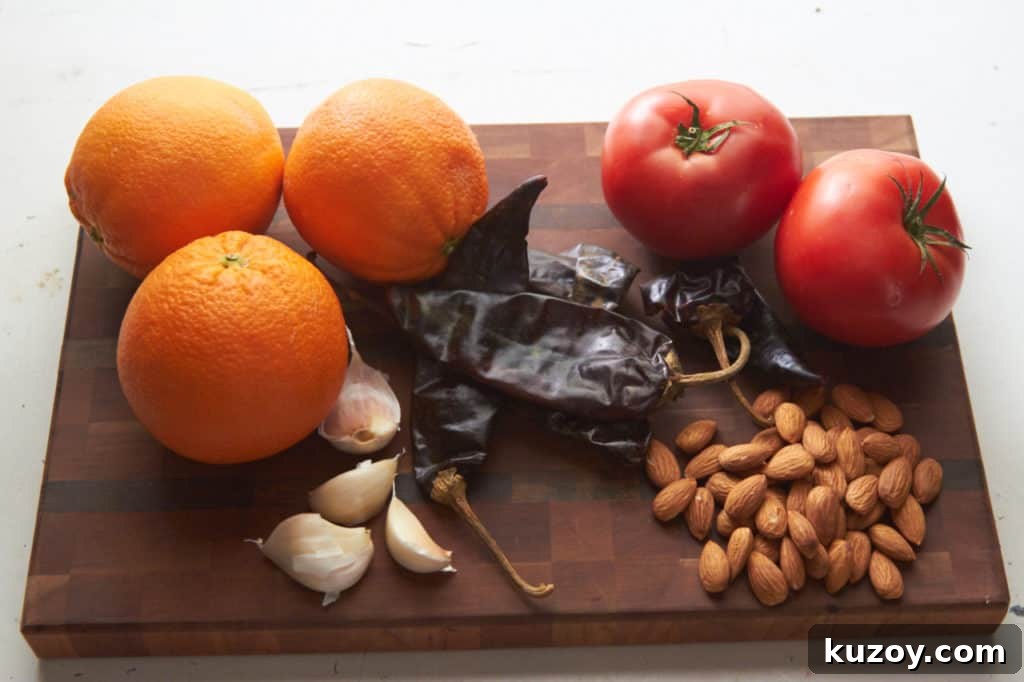 Orange-Almond Mole Sauce: Quick Recipe for Rich, Zesty Flavor 3 Ingredients for almond orange mole sauce: oranges, tomatoes, guajillo chiles, almonds and garlic displayed on a cutting board.