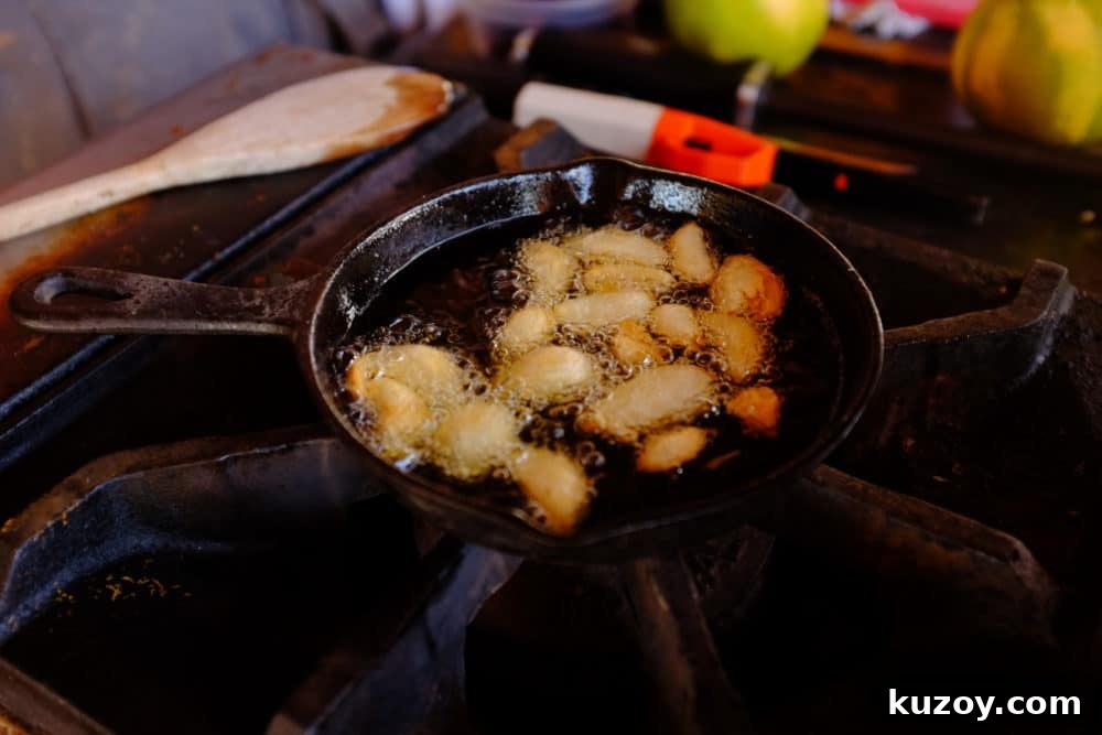 Orange-Almond Mole Sauce: Quick Recipe for Rich, Zesty Flavor 6 Almonds frying in a cast iron skillet on a large gas stovetop.